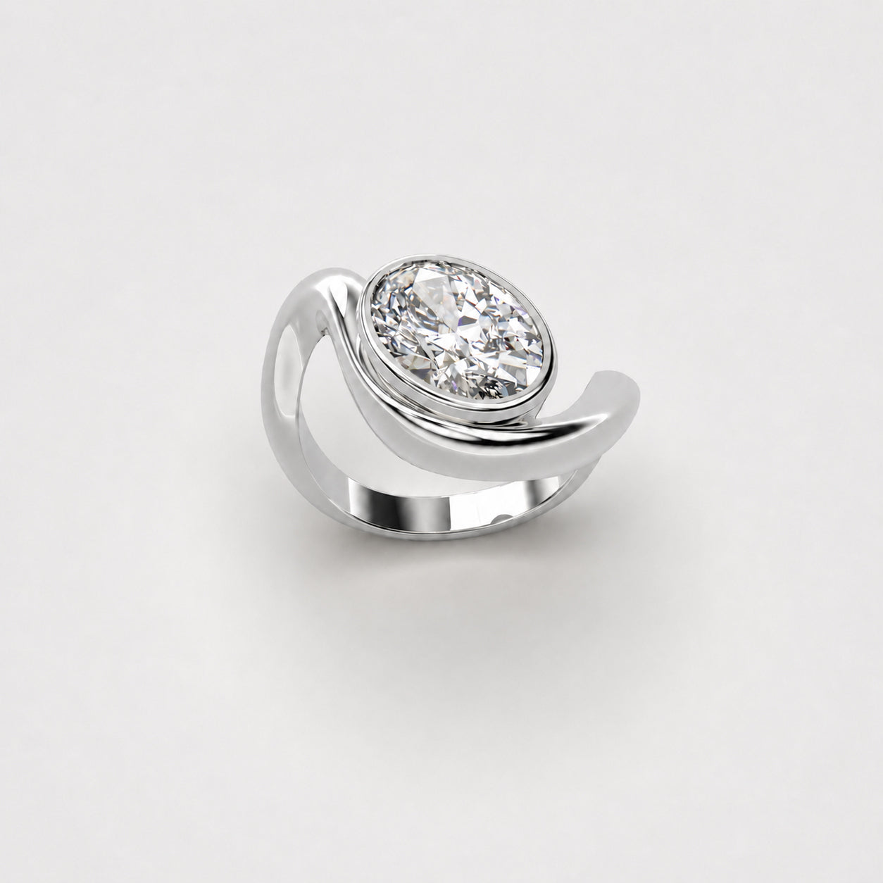 Organic white gold ring with oval diamond on a light grey background