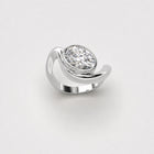 Organic white gold ring with oval diamond on a light grey background