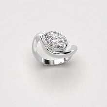 Organic white gold ring with oval diamond on a light grey background