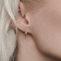 twisted golden hoop earrings with  diamonds