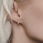 twisted golden hoop earrings with  diamonds
