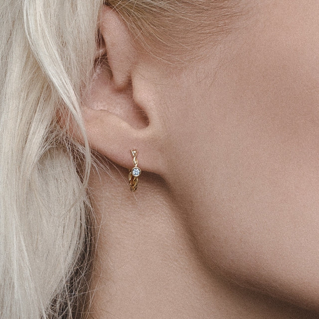 twisted golden hoop earrings with  diamonds