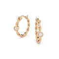 twisted golden hoop earrings with  diamonds